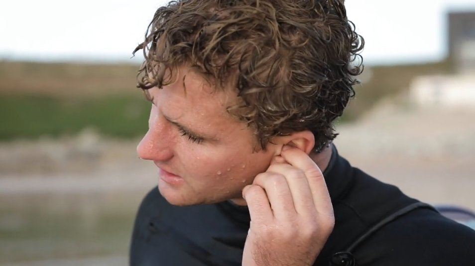 Surfer with water trapped in ear